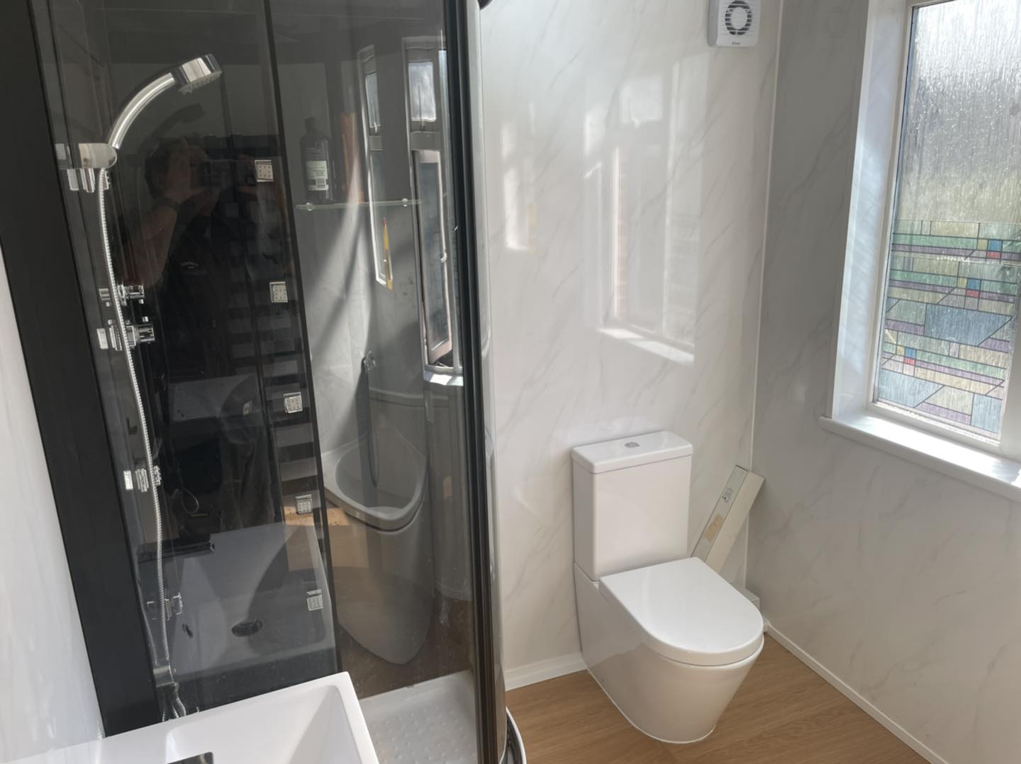 New corner shower and small toilet