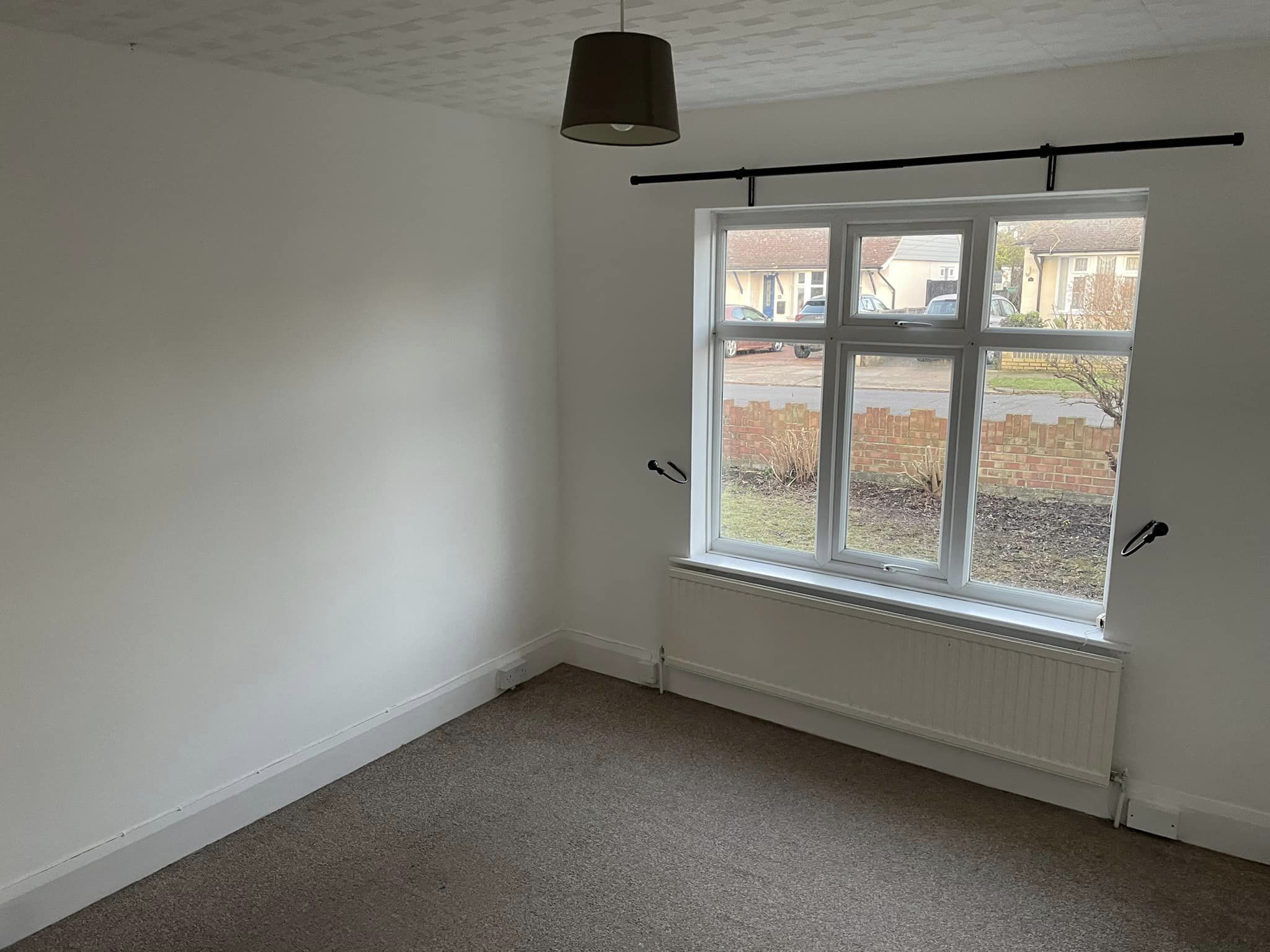 Fresh white paint on walls of small living room